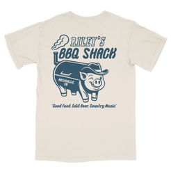 Beige t-shirt with blue graphic of a pig wearing a hat and text 'Riley's BBQ Shack' on a white background